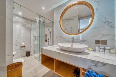 a bathroom with a sink and a mirror at Sejuk Suites in Legian