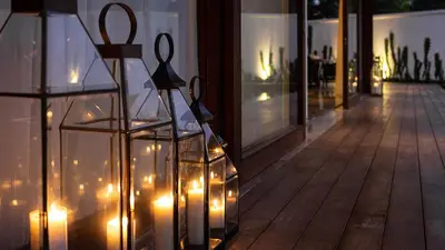 a pair of scissors in glass containers with lights on a building at Villa Indrani in Canggu