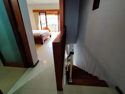 a hallway with a stairway leading to a bedroom at Balcony Living Apartment in Seminyak