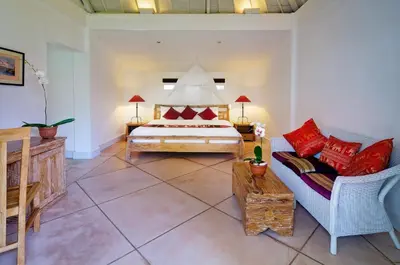 a bedroom with a bed and a couch at Villa Sipo in Seminyak