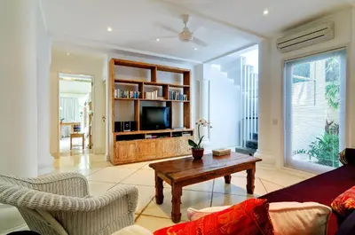 a living room with a couch and a table at Villa Sipo in Seminyak