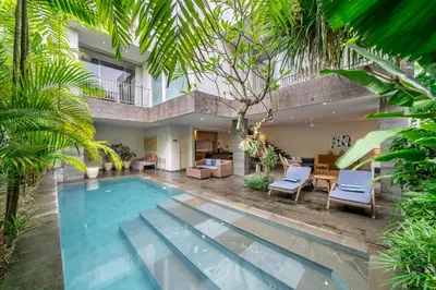 a villa with a swimming pool and a house at Villa Jekumah 2 in Seminyak
