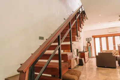 a living room with a staircase in a house at Charming Private Villa with Pool in Canggu
