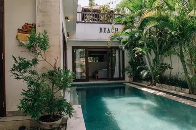 a swimming pool in front of a building with trees at Charming Private Villa with Pool in Canggu