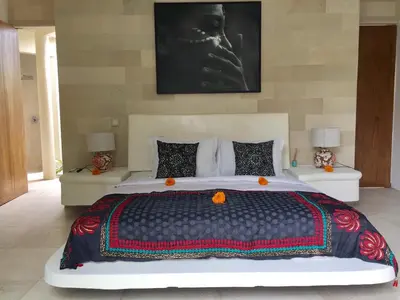 a bedroom with a large bed with a head board at Elegant Villa Casabianca - Tropical Pool & Garden, Near Potato Head Beach Club! in Seminyak