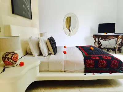 a white couch sitting in a room with pillows at Elegant Villa Casabianca - Tropical Pool & Garden, Near Potato Head Beach Club! in Seminyak