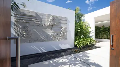 a facade of a house with a painting on it at Casa Brio in Seminyak