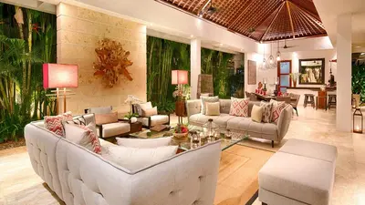 a living room with white couches and a table at Casa Brio in Seminyak