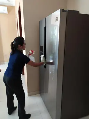a woman is standing in front of a refrigerator at Villa Alessandra Seminyak By Bali Asia Villa in Seminyak