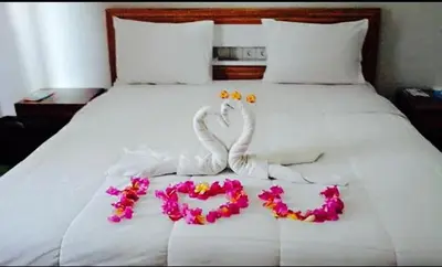 a white bed with two swans made out of flowers at Tanjung Sari Inn in Nusa Dua