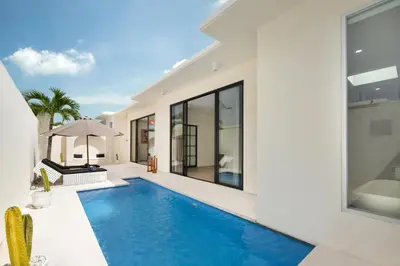 a swimming pool in the backyard of a house at The Grand Daha Luxury Villas in Seminyak