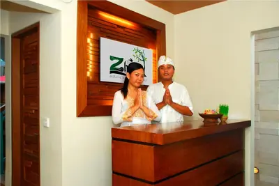 a man and a woman standing at a bar at The Green Zhurga Suite Seminyak in Kerobokan