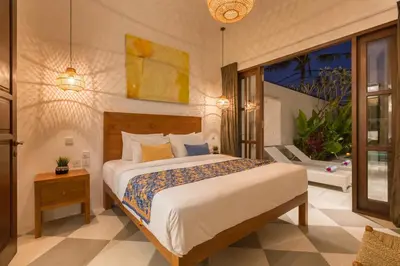 a bedroom with a large bed in a room at Villa CJ Seminyak in Seminyak
