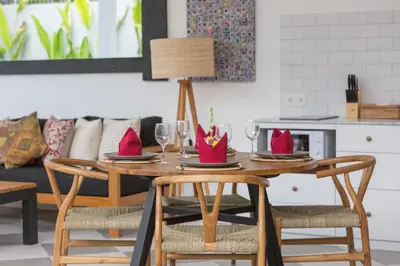 a dining room table with chairs and wine glasses at Villa CJ Seminyak in Seminyak