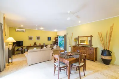 a living room with a table and a couch at Beach Melati Apartments in Legian