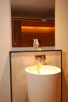 a sink in a bathroom with a mirror at DBeds Kuta Beach in Kuta