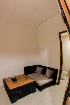 a living room with a couch and a table at DBeds Kuta Beach in Kuta