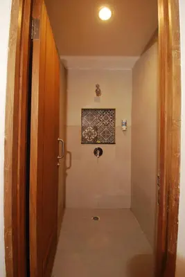 a hallway with a door leading to a bathroom at DBeds Kuta Beach in Kuta