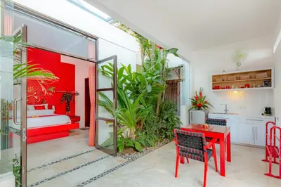 a living room with a red table and a red room at Bali Ginger Suites & Villa in Seminyak