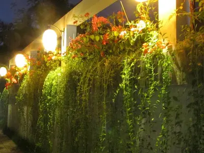 a fence with plants and flowers on it at Bali Ginger Suites & Villa in Seminyak