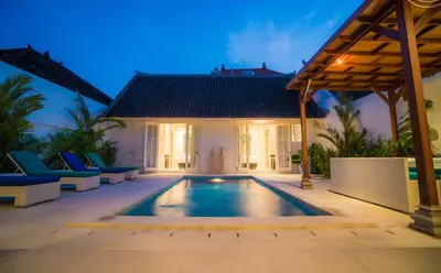 a pool in the backyard of a villa at night at Villa Ley Double Six by Best Deals Asia Hospitality in Seminyak