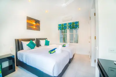 two white beds in a room with a television at Villa Ley Double Six by Best Deals Asia Hospitality in Seminyak