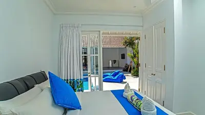 a living room with a couch and a table with blue pillows at Villa Ley Double Six by Best Deals Asia Hospitality in Seminyak