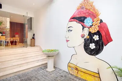 a mural of a woman painted on the side of a building at The Jimbaran Villa by Ini Vie Hospitality in Jimbaran