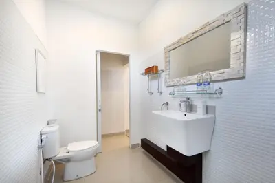 a white bathroom with a sink and a toilet at Best Location 7 Bed, 7,5 Bath Pool Villa, near beach in Kuta