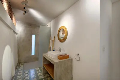 a bathroom with a sink and a mirror on the wall at Best Location 7 Bed, 7,5 Bath Pool Villa, near beach in Kuta