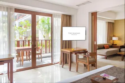 a living room with a view of a balcony at The Magani Hotel and Spa in Legian