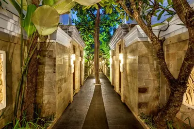 a narrow alleyway with trees on either side at Best Western Kuta Villa in Kuta