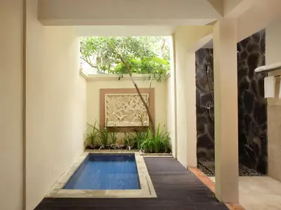 a swimming pool in the middle of a house at Best Western Kuta Villa in Kuta