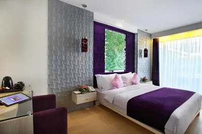 a bedroom with a large bed and a window at Grand Mega Resort & Spa Bali in Kuta