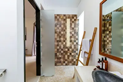 a bathroom with a sink and a mirror at Villa Serasi in Canggu