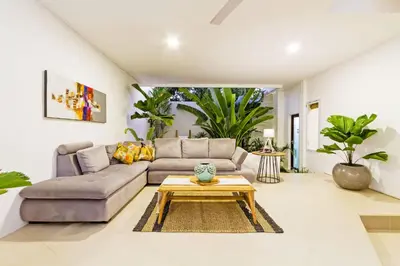 a living room with a couch and a coffee table at Villa Serasi in Canggu