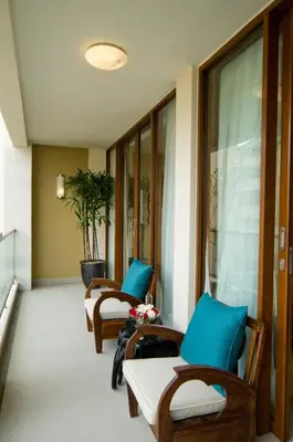 a row of chairs and tables in a room at Kuta Luxury Residence in Kuta
