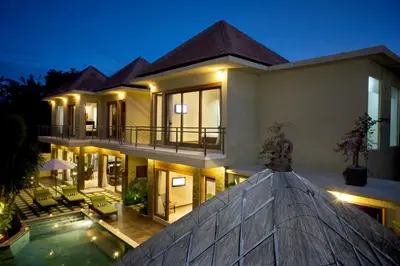 a villa with a swimming pool at night at O Villas Seminyak in Seminyak