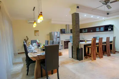 a dining room and kitchen with a table and chairs at O Villas Seminyak in Seminyak