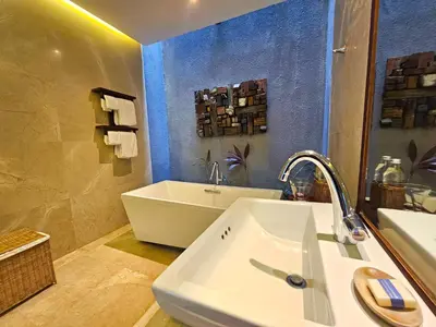 a bathroom with a sink and a bath tub at Seminyak Icon - by Karaniya Experience - CHSE certified in Seminyak
