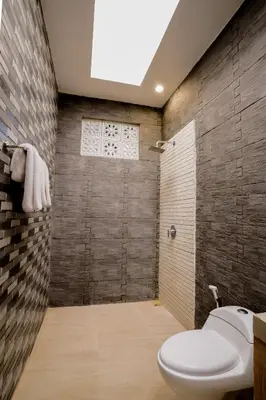 a bathroom with a toilet and a shower at The Catur Villa Seminyak in Seminyak