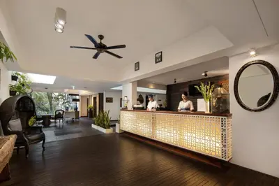 a restaurant with a bar with a mirror at The Akmani Legian in Legian