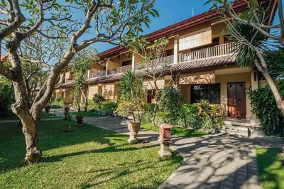 a house with a garden in front of it at Kuta Puri Bungalows, Villas and Resort in Kuta
