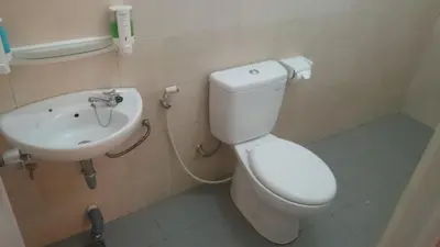 a bathroom with a toilet and a sink at Agus Beach Inn in Kuta