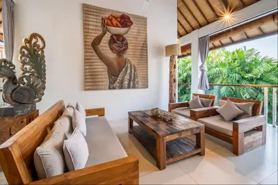 a living room with a couch and a table at Villa Lagoon Canggu in Canggu