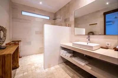a bathroom with a sink and a mirror at Villa Lagoon Canggu in Canggu