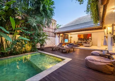 a backyard with a swimming pool and a house at Villa Lagoon Canggu in Canggu