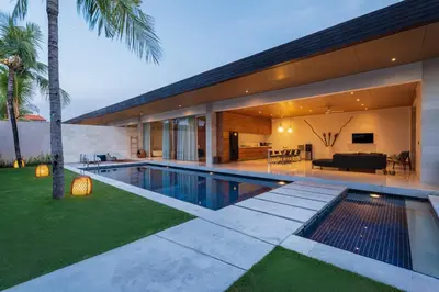 a house with a swimming pool in front of it at One Eleven in Seminyak