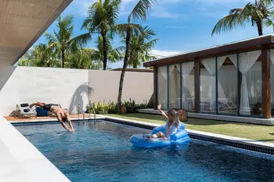 a man and a woman in a pool with an inflatable at One Eleven in Seminyak