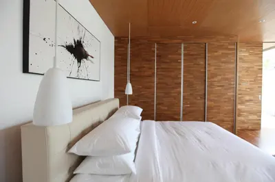 a bedroom with a white bed with two pillows at One Eleven in Seminyak